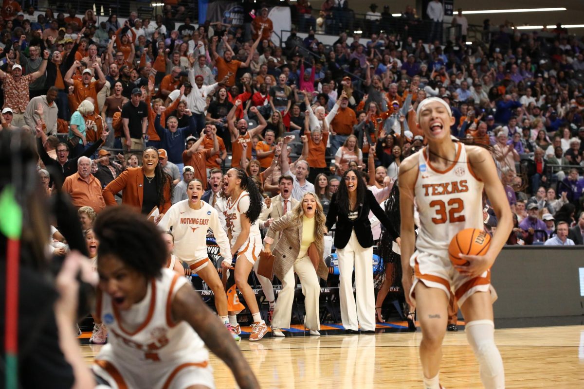 Texas women's basketball team and fans celebrate a play during the NCAA March Madness Elite Eight game against TCU in Birmingham, Alabama on Mar. 31, 2025.