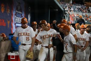 Sophomore outfielder Tommy Farmer IV is welcomed into the dugout after getting a run during Texas' game against Oklahoma State Feb. 16, 2025.