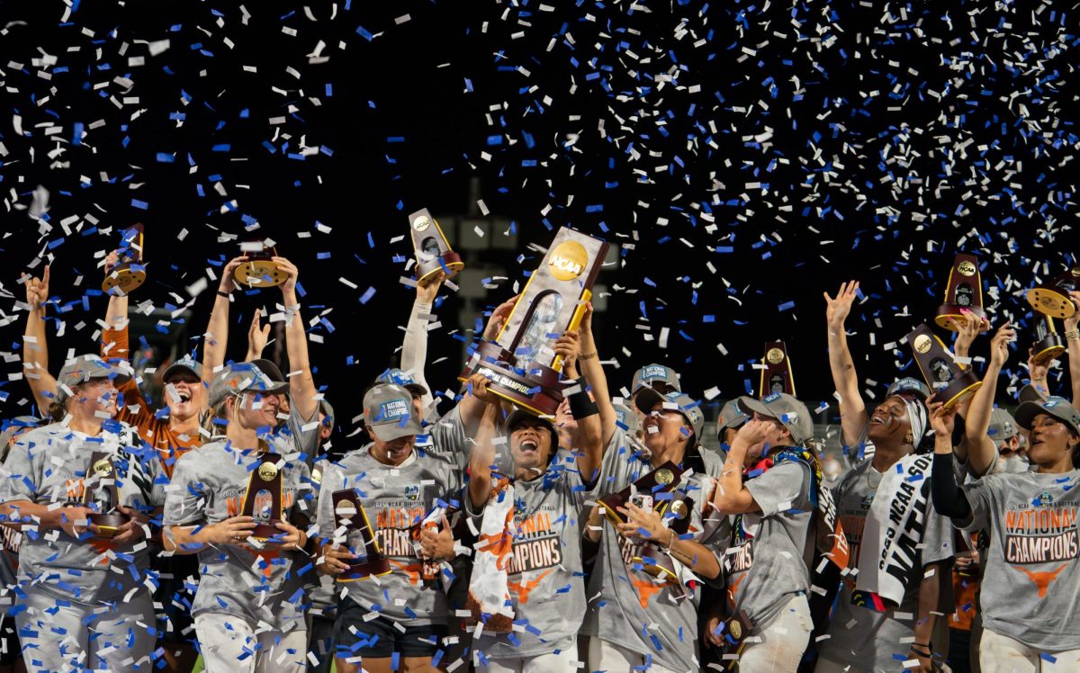 Sophomore Kayden Henry lifts the National Championship trophy in celebration and smiles with her teammates after a 10-4 victory over the Texas Tech Red Raiders to clinch Texas softball’s first-ever national championship on June 6, 2025. 