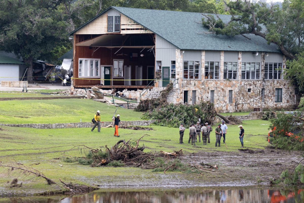 Law enforcement agents outside of a torn building at Camp Mystic on Sunday, July 6, 2025. Law enforcement and volunteers are in search for missing people due to heavy rainfall that caused flooding along Guadalupe River.