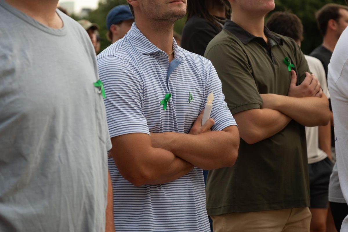 Attendees wear green ribbons at the vigil on July 8, 2025.
